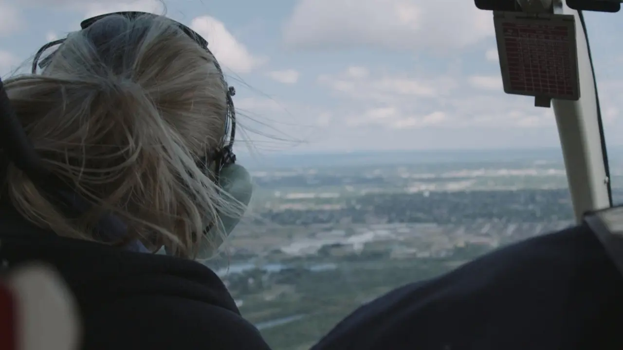 Helicopter flying over a vast wetland landscape, illustrating the scale and importance of conservation filmmaking.